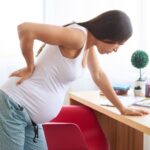 Почему болит спина во время беременности